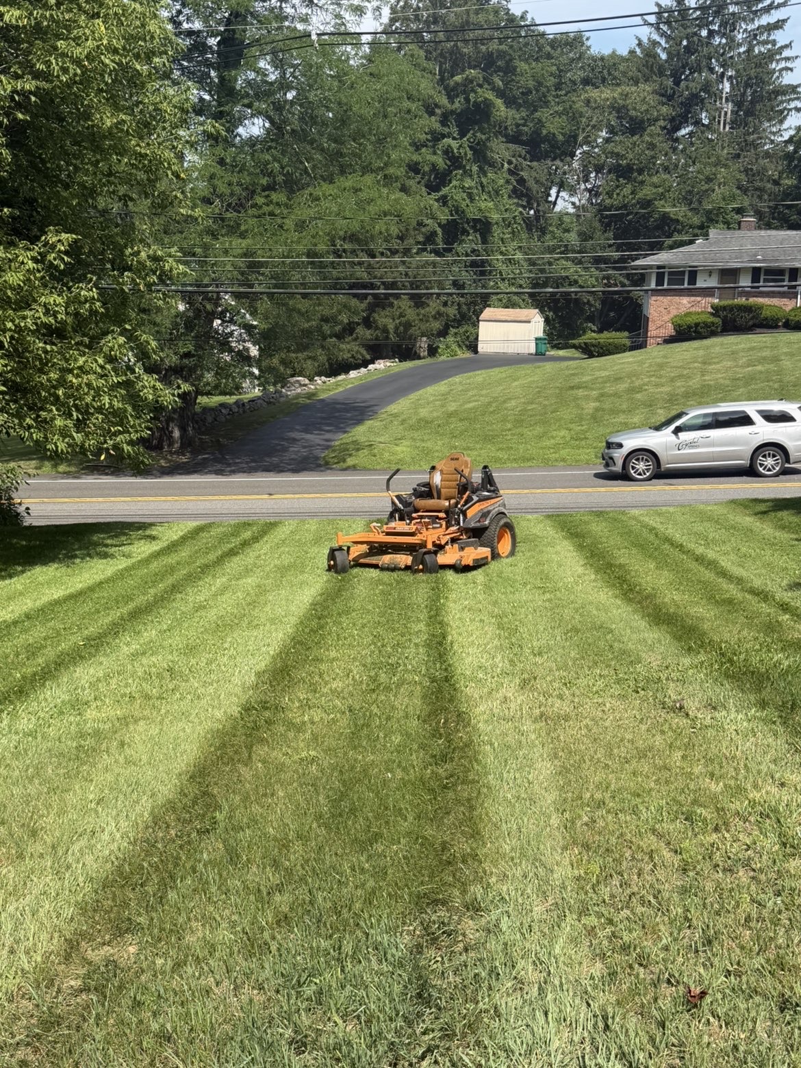 Commercial zero-turn mower cutting clean stripes into a lawn